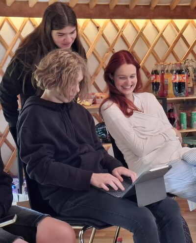 drei Jugendliche schauen gemeinsam auf ein Tablet